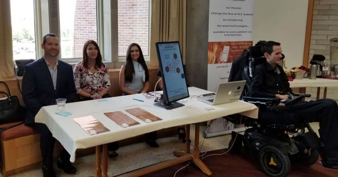 Photo of three people behind a folding table, and one in a wheelchair, at an event raising awareness for ALS. The photo is for an article about 50 ways to use FileMaker.