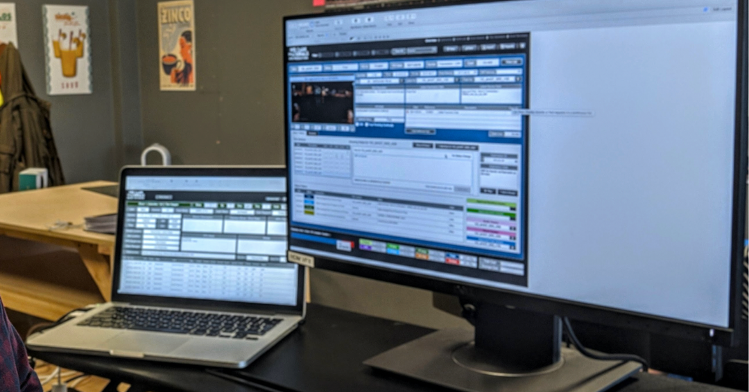 Photo of a modernized FileMaker solution being used on a laptop and large monitor.